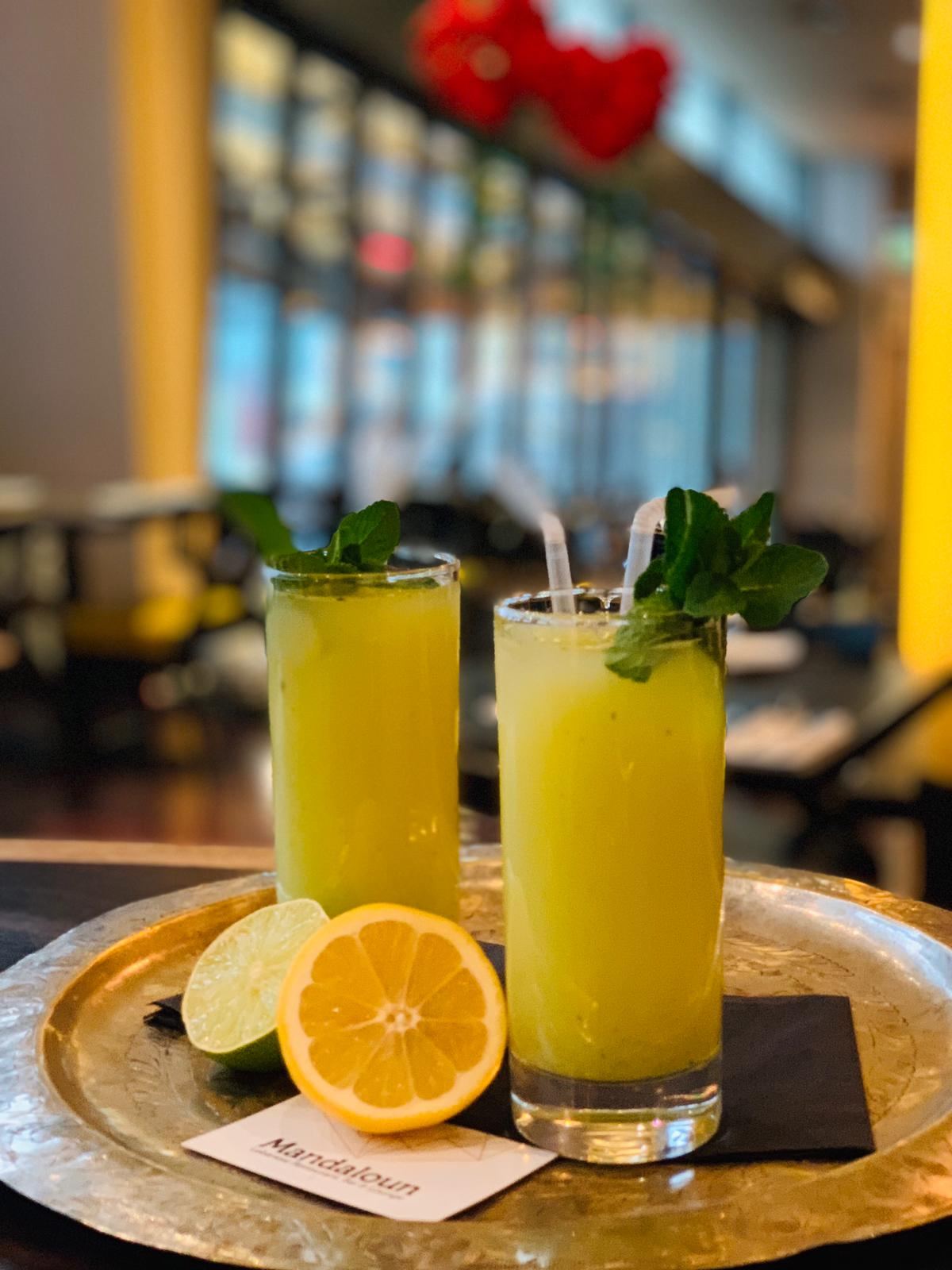 Fresh juices with mint on a brass tray