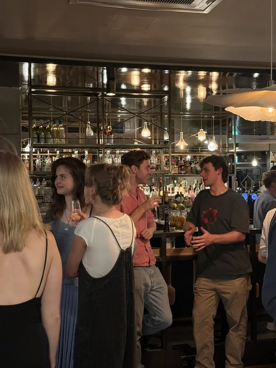 Guests talking at the bar at The Reach Riverside, Fulham Reach