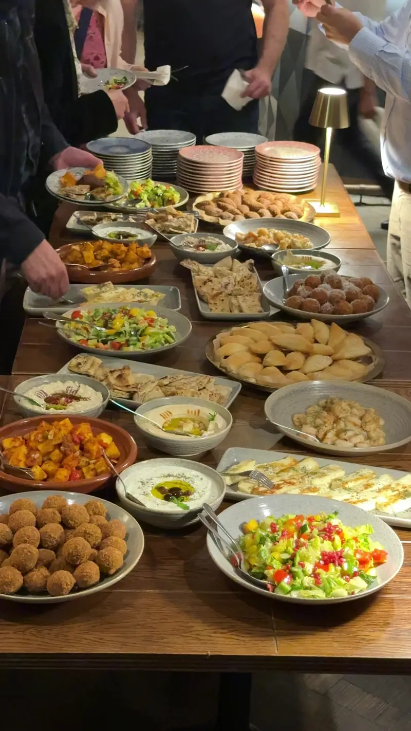 Sharing plates laid out on a long table at The Reach Riverside